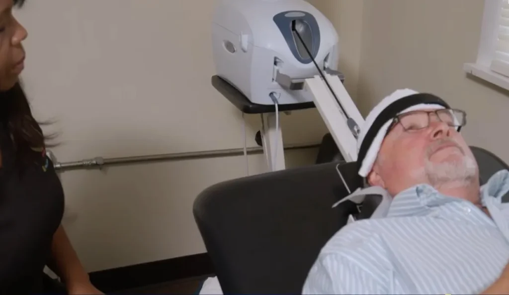 Patient giving a thumbs up during cervical traction therapy